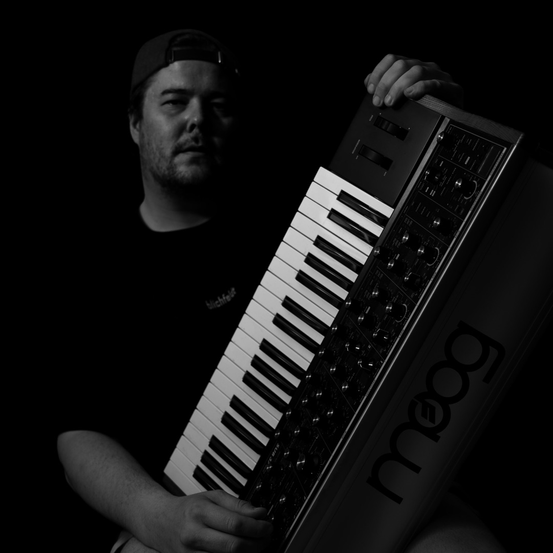 Blichfeldt holding a Moog synthesizer